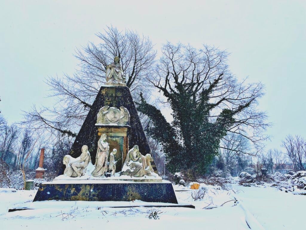 Snowy cemetery sculpture with monument