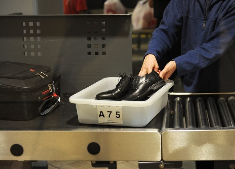 US-AIRLINE-HOMELAND SECURITY-TSA-LAX An air traveler puts their shoes in a bin at an airport security checkpoint