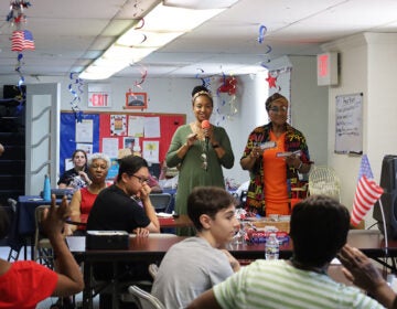 A woman speaks to a group at the North Light Community Center