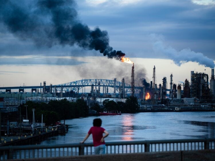 a child looks on at the Philadelphia Energy Solutions fire