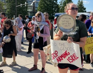 activists hold pots and signs, one reading END THE GENOCIDE STOP ARMING ISRAEL and a pot with the writing PEOPLE ARE 