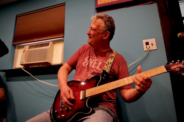 Guitarist Rich Hill rehearses for an upcoming Live Aid tribute performance