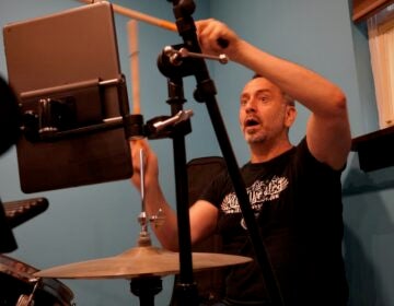 Drummer Ned Sonstein rehearses for an upcoming Live Aid tribute performance