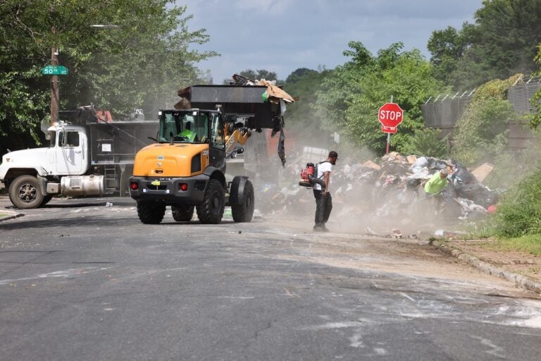 Non-union workers clear away trash at drop-off site at 51st Street and Wyalusing Avenue