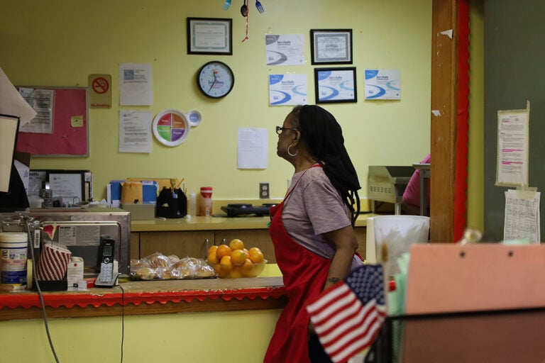 philadelphia_aging_resources1_07262025 A woman helps kitchen staff at a senior community center