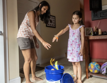 Kim Paymaster and her daughter Ziya, 7, compost food scraps