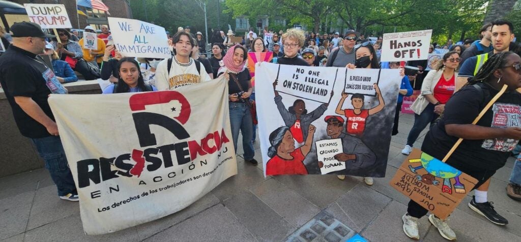 People at a rally holding up signs