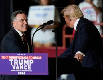 David McCormick, left, walks on stage to greet Republican presidential candidate former President Donald Trump