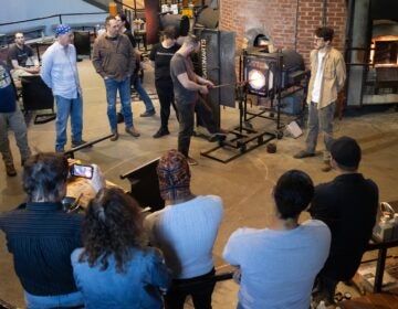 A class at WheatonArts gets a lesson on glass blowing