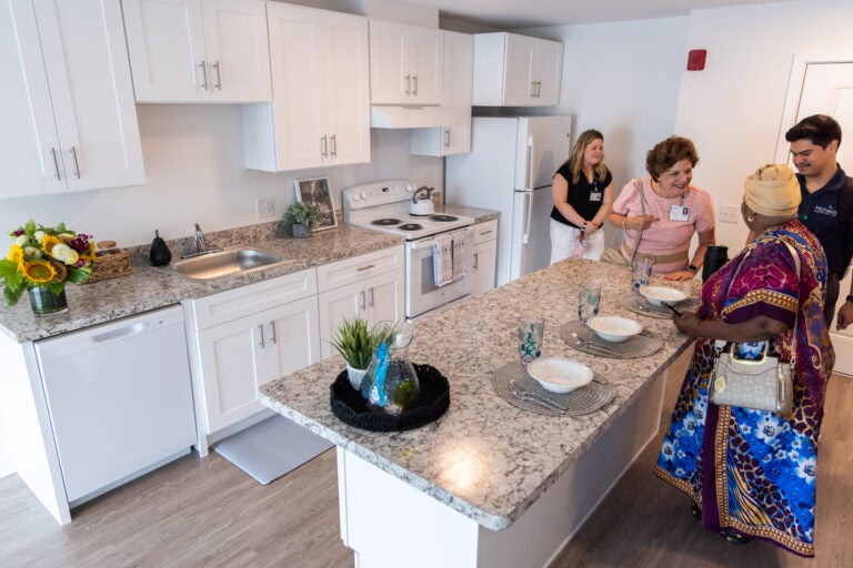 People inside a senior apartment at the new Oliver Station