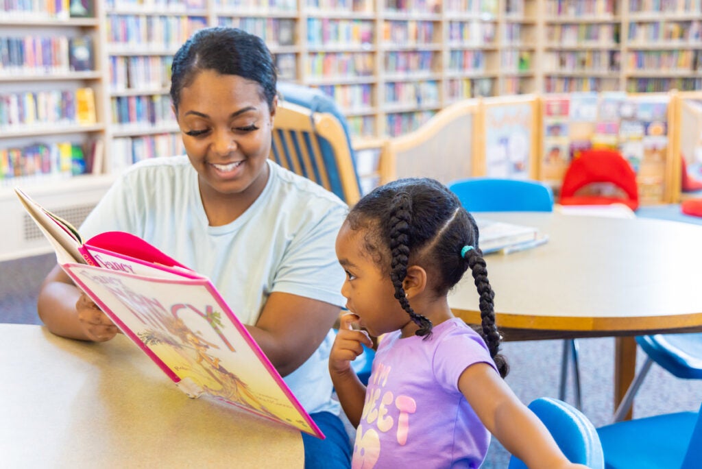 Niya Pugh reading to Zia at Richmond Library