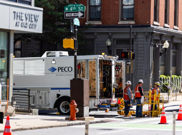 Workers congregate around a PECO truck