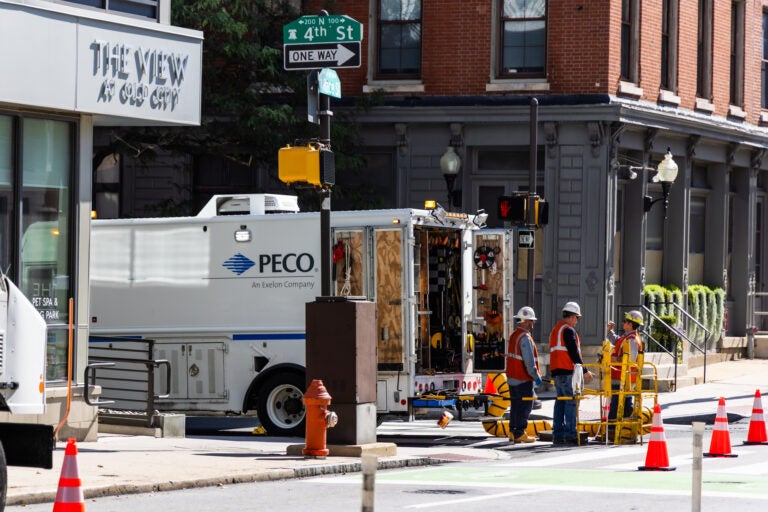 Workers congregate around a PECO truck