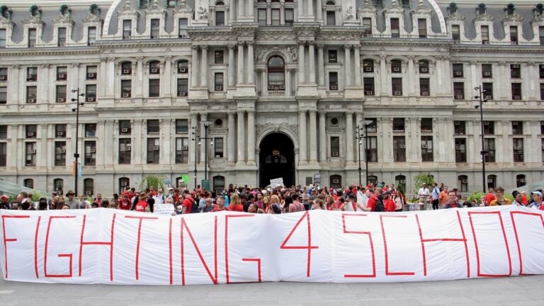 2017 05 01-e lee-philadelphia city hall-teachers protest Teachers hold up a large sign in front of City Hall at the protest that reads 'FIGHTING 4 SCHOOLS'