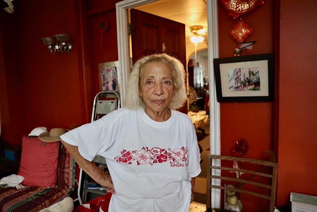 Blanca Maldonado stands on the porch of her home