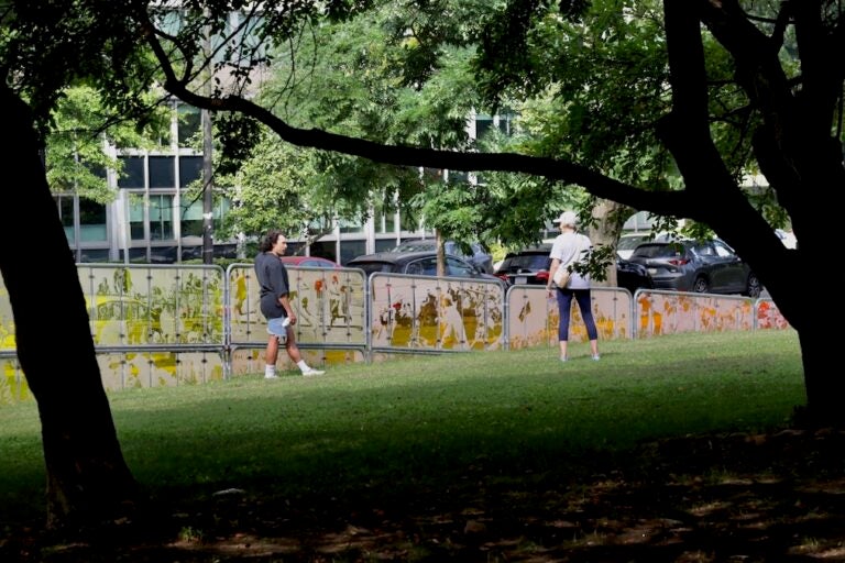A passerby speaking with artist Nicolo Gentile (left) about his sculpture at Maja Park