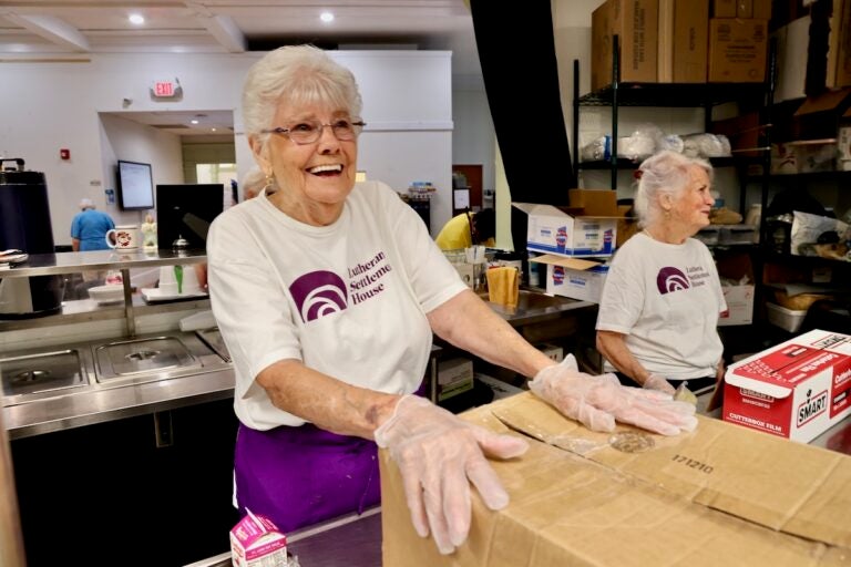 Marge Wible smiling while volunteering at Lutheran Settlement House
