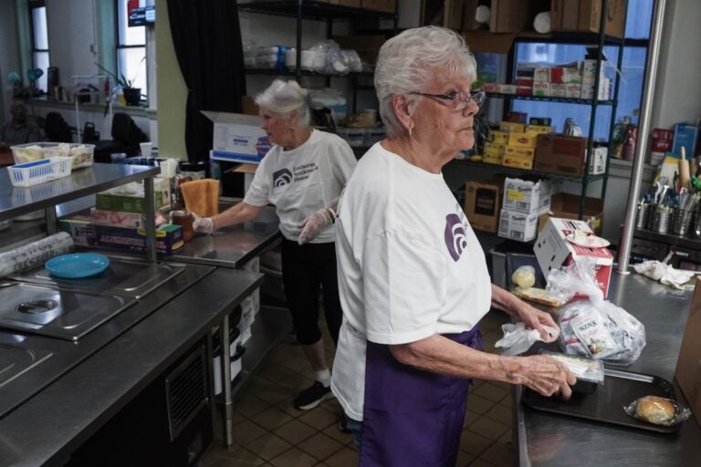 Joan Creamer, 83, and Marge Wible, 90, work in the kitchen at Lutheran Settlement House