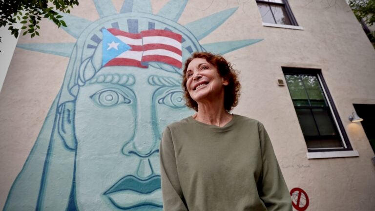 2025 08 20-e lee-jane golden-philadelphia mural arts-puerto rican statue of liberty Jane Golden poses in front of her first murals