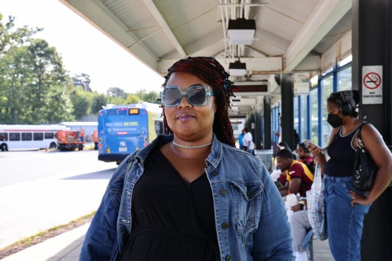 A woman poses for a photo at the bus station