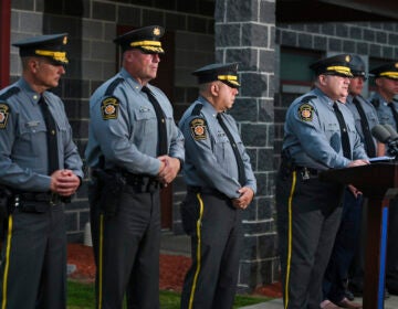 Pennsylvania State Troopers stand in line during a press conference