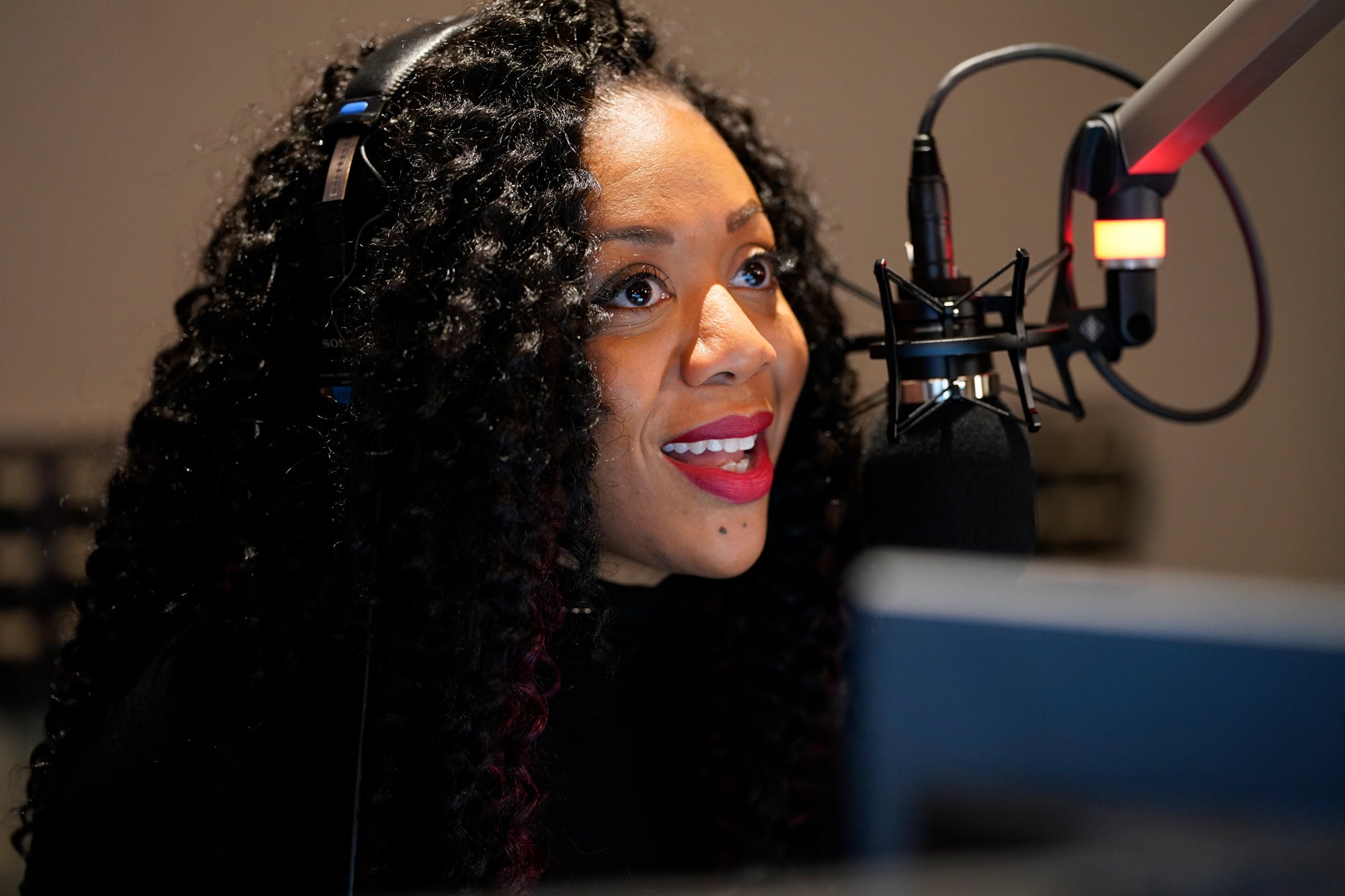 WHYY Studio 2 host and newscast anchor Cherri Gregg talking into a microphone