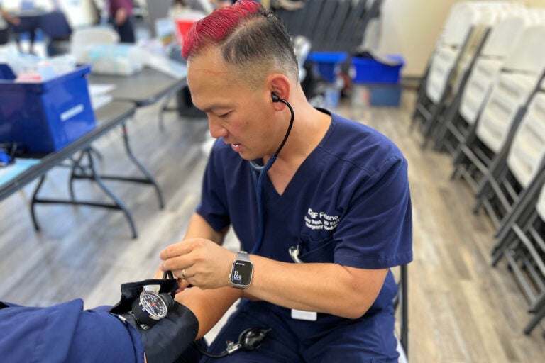 Mobile HeaL_1200 Emergency medicine physician Kenny Banh measures a patient’s blood pressure. (Courtesy of UCSF Fresno)
