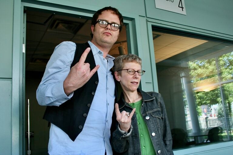 Terry Gross and Rainn Wilson posing with rock on hand gestures