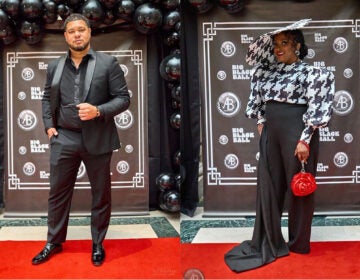 A man and woman in fancy clothes at a red carpet event