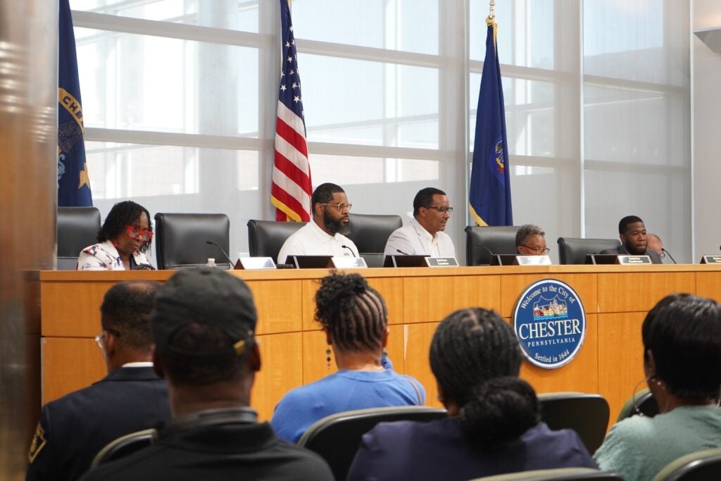 Council members seated during a hearing