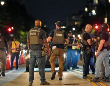 Federal agents standing in the street with D.C. police