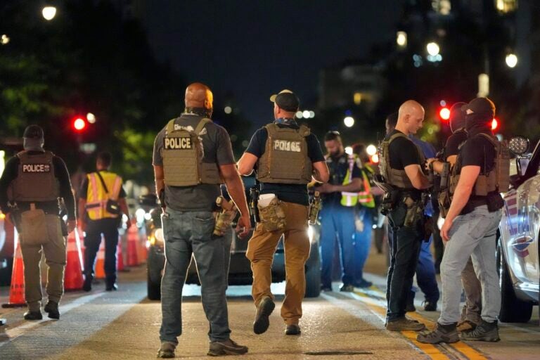 Federal agents standing in the street with D.C. police