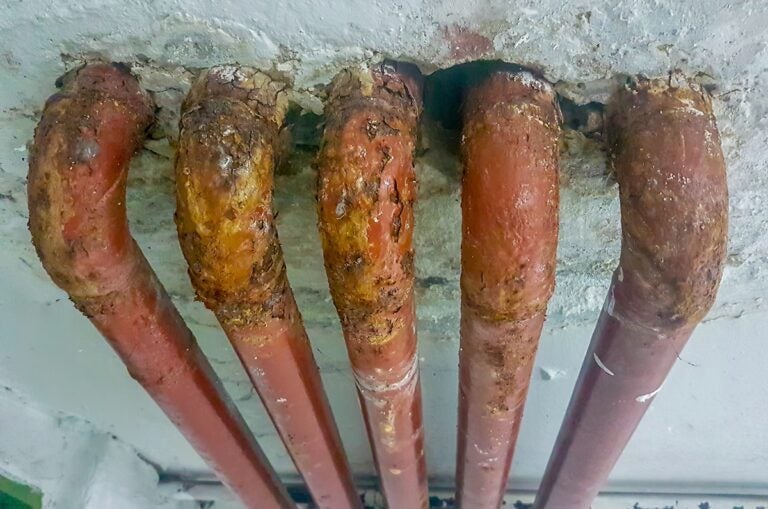 several old lead pipes in a wall