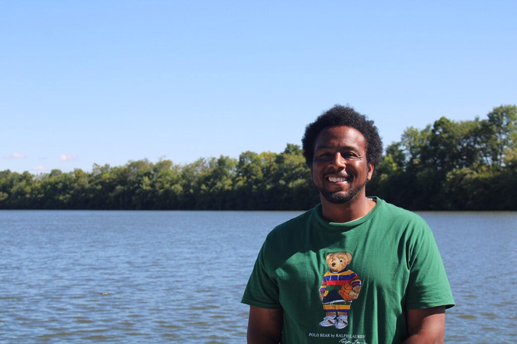 Ihsan Hines, founder and president of My Brother's Keeper Cares, poses for a photo in front of a lake