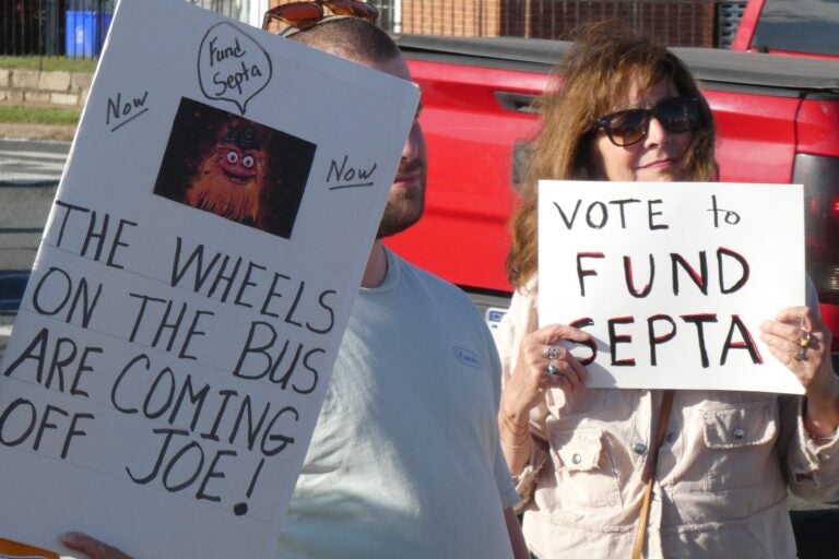 SEPTA rally goers hold signs