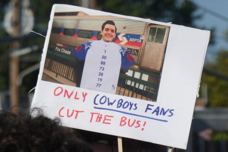 a sign with Picozzi's face reads ONLY COWBOYS FANS CUT THE BUS!