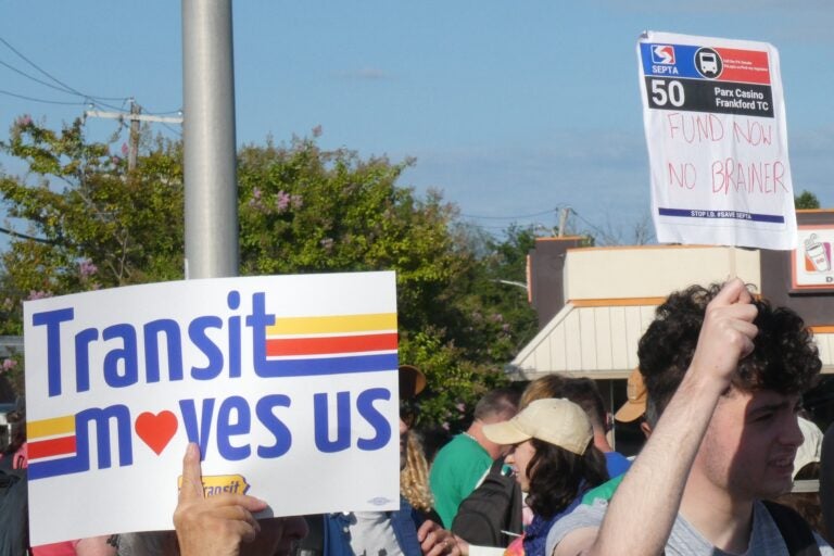 One sign reads Transit moves us while another reads FUND NOW NO BRAINER