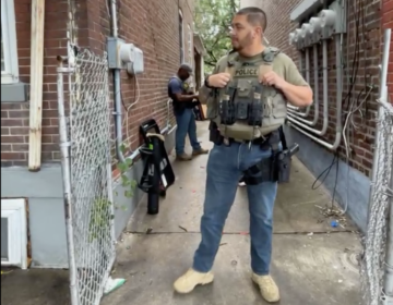ICE agents standing in an alleyway