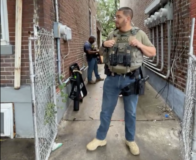 ICE agents standing in an alleyway