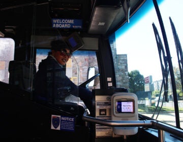 A SEPTA bus driver sits in the driver's seat of a SEPTA bus