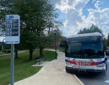 A bus pulling up to a bus stop