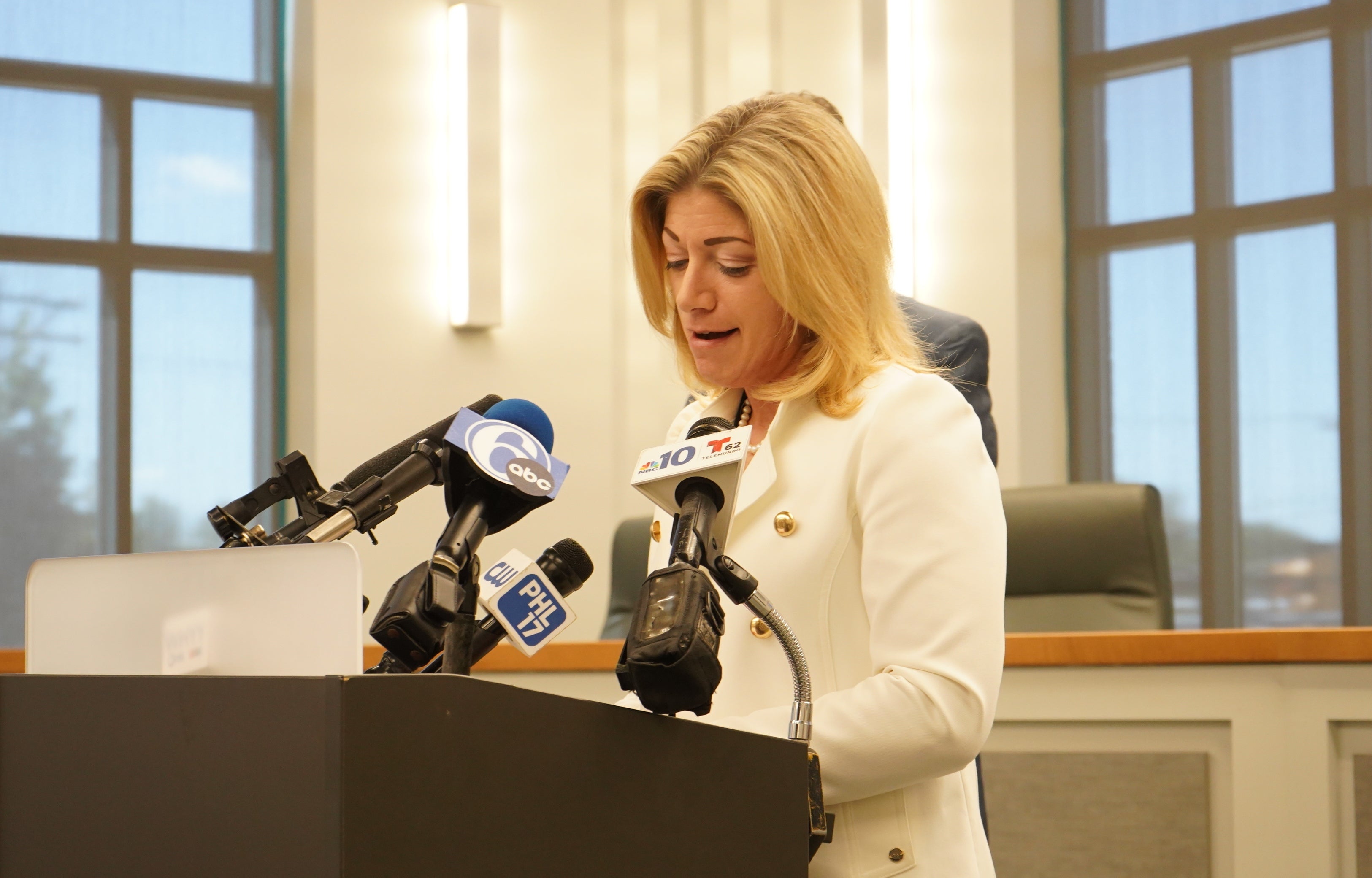 Katie Muth speaks at a podium