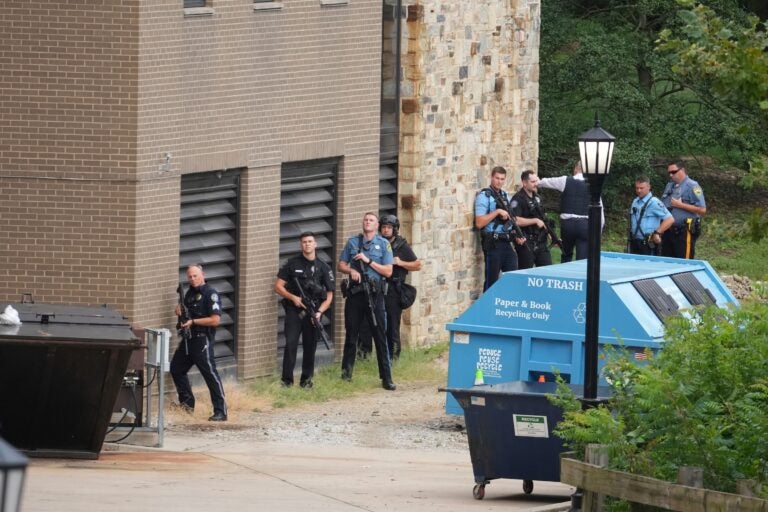 Villanova Reported Shooting Police officer lining up behind a wall with their guns