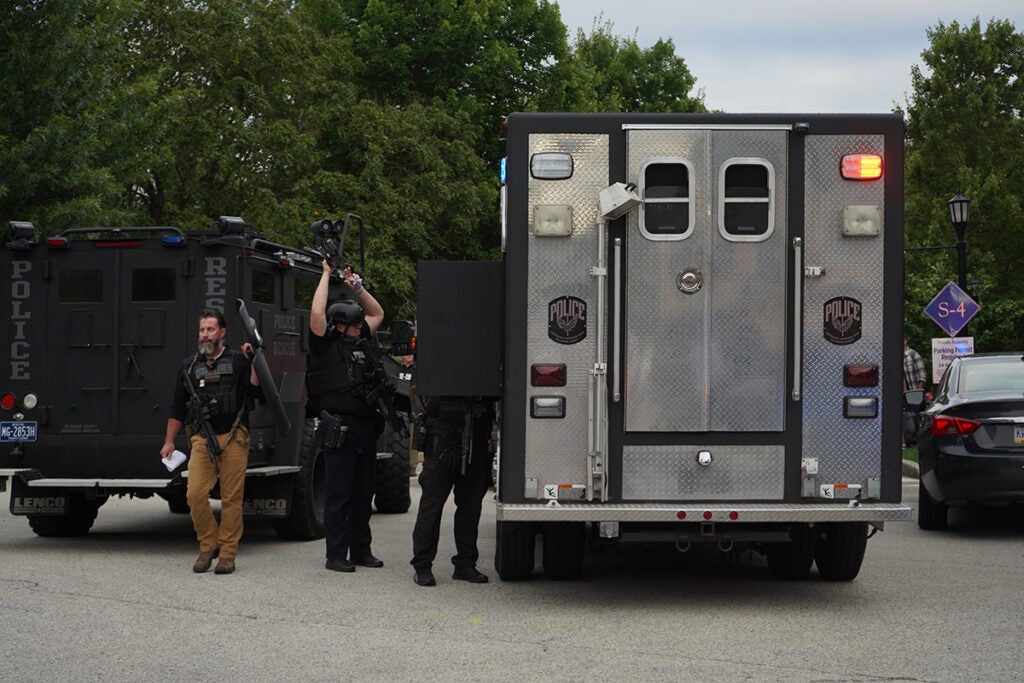 Police stand near armored vehicles on the Villanova University campus