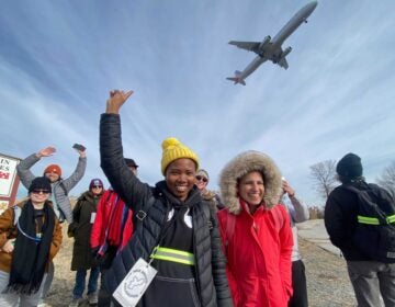 Walk Around Philadelphia participants watching a plane overhead