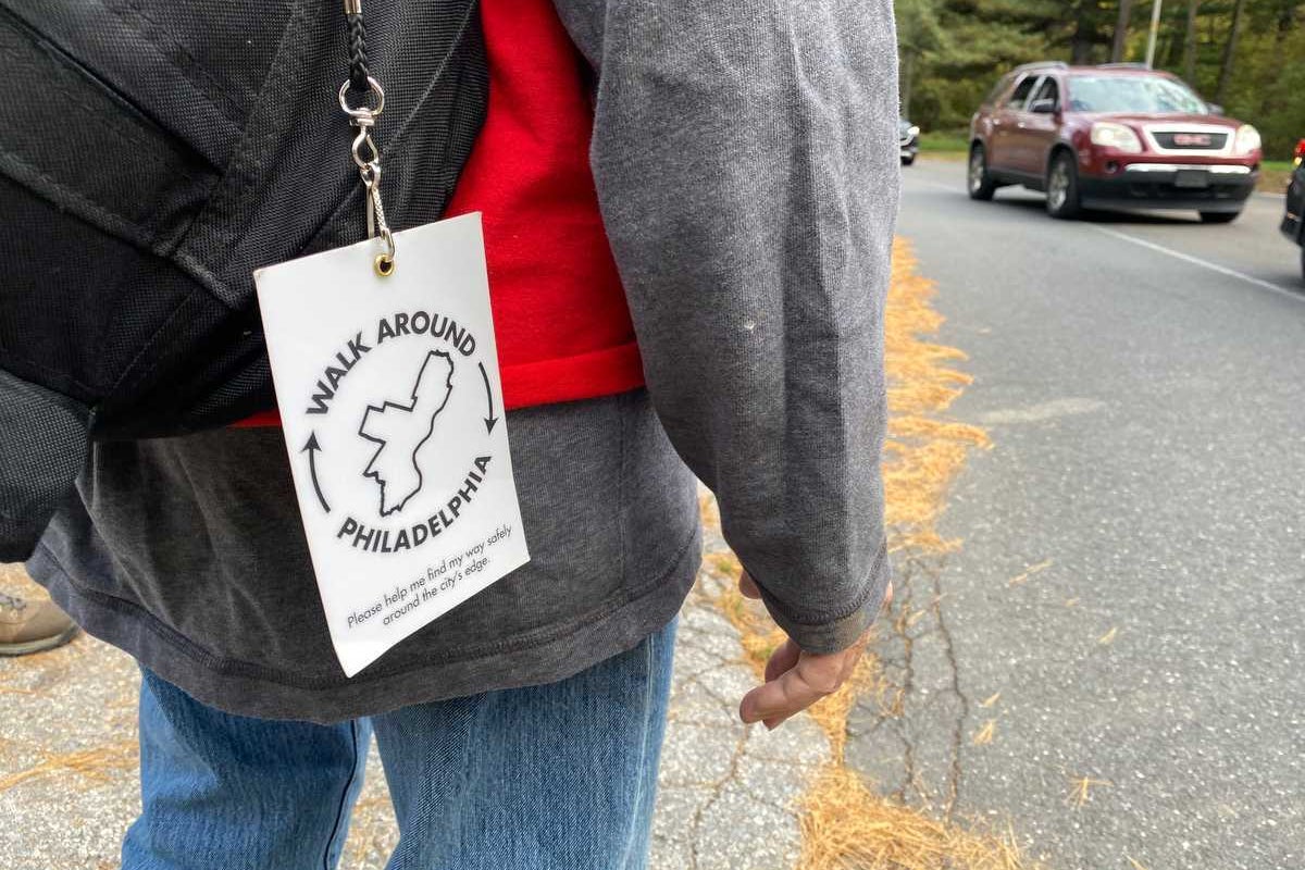 a person wears a tag for Walk Around Philadelphia