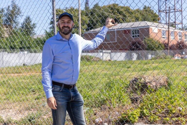 Philip Balderston posing for a photo near the lot that will be developed