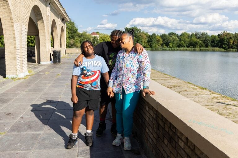 A mother posing for a photo with her two children