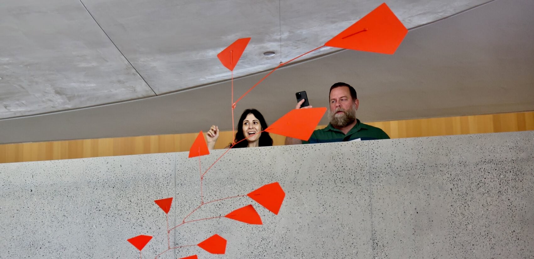 Visitors look at a hanging sculpture in Calder Gardens