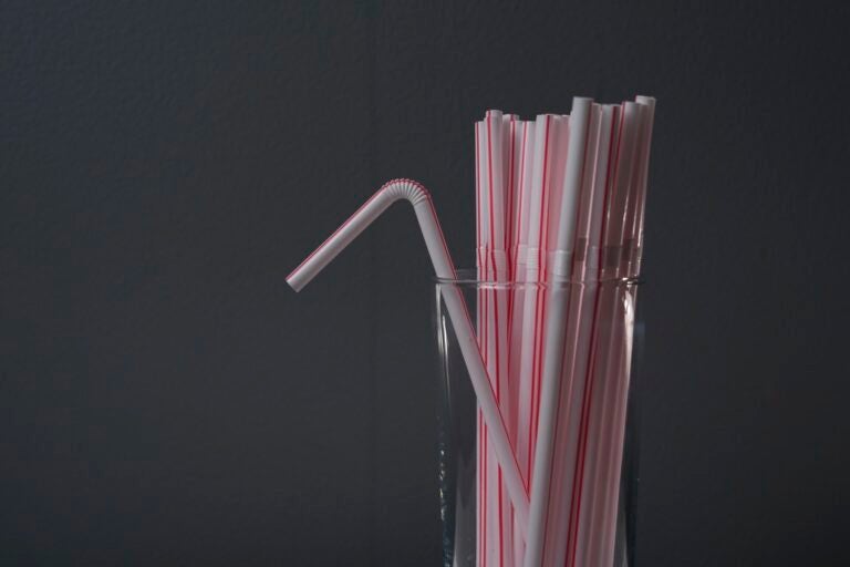 Plastic straws are displayed in a glass